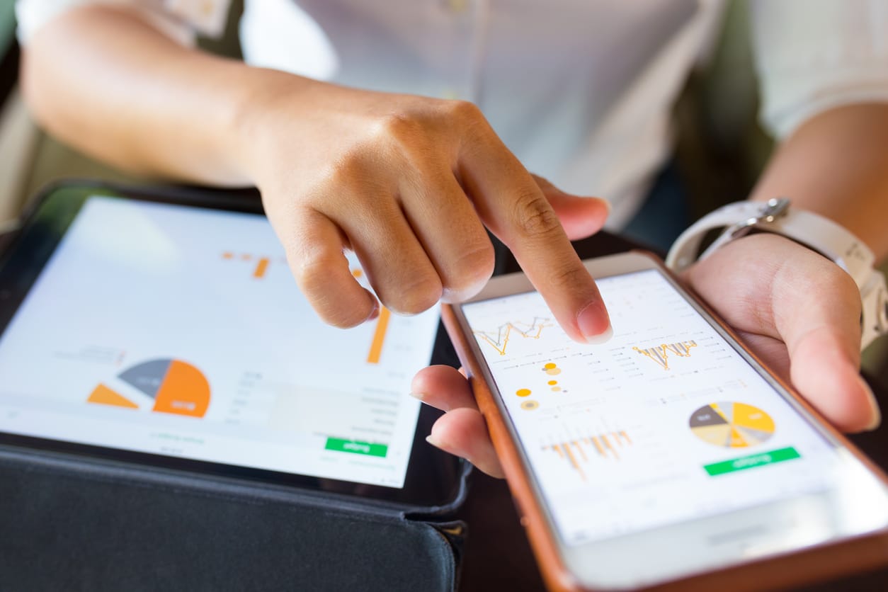 Businessman using a tablet device in checking his business statistics. Microsoft Forms concept.